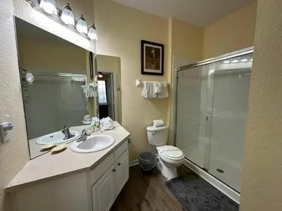 a bathroom with a sink and a shower and a toilet at Delight Condo Water Park Near Disney Parks in Orlando