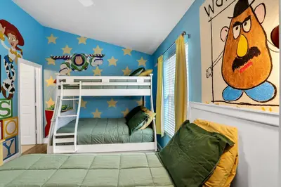 a childs bedroom with a bunk bed and a cartoon at Water Park Haven: Spacious 3BR Windsor Hills in Orlando