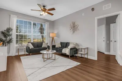a living room with a couch and a ceiling fan at Elegant Getaway Windsor Hills Condo w Water Park in Orlando