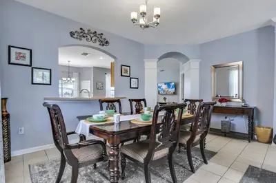 a dining room with a table and chairs at Family Fun Haven: Spacious Villa Water Park in Orlando