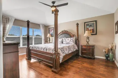 a bedroom with a bed and a ceiling fan at Family Fun Haven: Spacious Villa Water Park in Orlando
