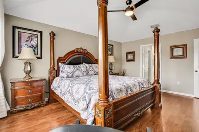 a bedroom with a canopy bed and a wooden dresser at Family Fun Haven: Spacious Villa Water Park in Orlando