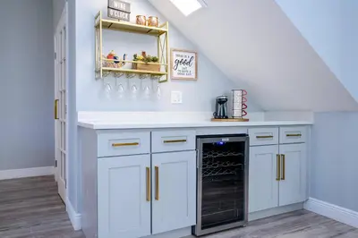 a kitchen with white cabinets and a black dishwasher at FREE Water Park Fun Included Large Resort Home in Orlando