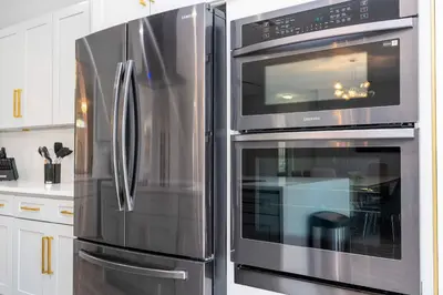 a stainless steel refrigerator and oven in a kitchen at FREE Water Park Fun Included Large Resort Home in Orlando