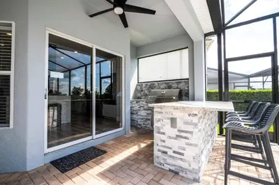 a patio with a bar with two stools at FREE Water Park Fun Included Large Resort Home in Orlando