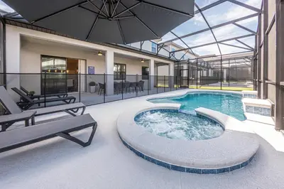 a swimming pool in a building with a glass ceiling at Luxury Meets Adventure 8BR Condo with Themed Rooms in Orlando