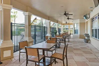 a row of tables and chairs on a balcony at Vacation Haven Windsor Hills Condo with Water Park in Orlando