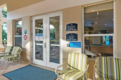 a store front with chairs and signs on the door at Vacation Haven Windsor Hills Condo with Water Park in Orlando