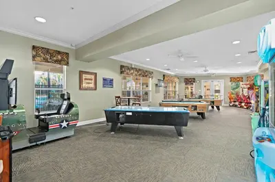 a game room with a pool table and other games at Vacation Haven Windsor Hills Condo with Water Park in Orlando