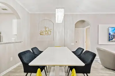a dining room with a white table and chairs at Vacation Haven Windsor Hills Condo with Water Park in Orlando