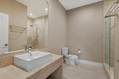 a bathroom with a white sink and a toilet at Elegant Escape: 4BR Villa near Disney Views in Orlando