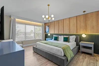 a bedroom with a large bed and a television at Group Getaway Paradise: Large Home Water Park in Orlando