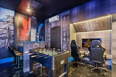 a room with a foosball table and chairs at Group Getaway Paradise: Large Home Water Park in Orlando