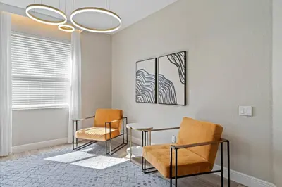 a waiting room with two chairs and a table at Group Getaway Paradise: Large Home Water Park in Orlando
