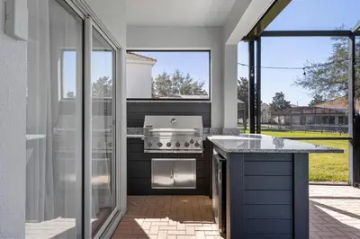 a kitchen with a stove and a large window at Group Getaway Paradise: Large Home Water Park in Orlando