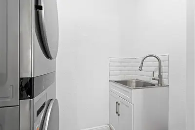 a kitchen with a sink and a refrigerator at Group Getaway Paradise: Large Home Water Park in Orlando