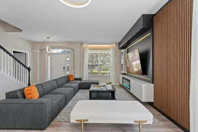 a living room with a couch and a tv at Group Getaway Paradise: Large Home Water Park in Orlando