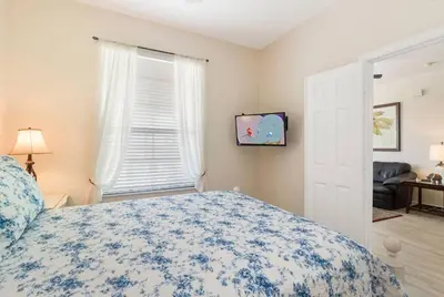 a bedroom with a bed with a blue and white bedspread at Windsor Hills Getaway: Condo with Water Park in Orlando