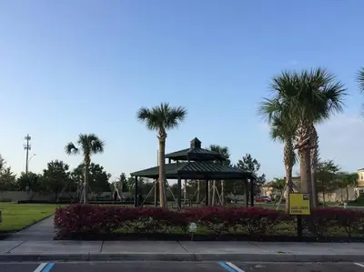 a park with palm trees and a gazebo at Family Paradise 4BR Compass Bay Townhome Sleeps 11 in Kissimmee