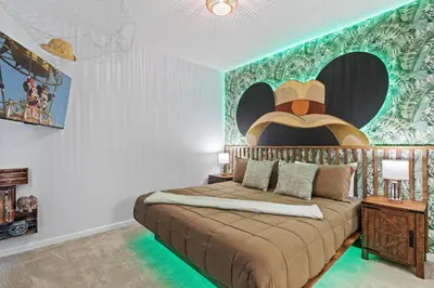 a bedroom with a bed with a painting on the wall at Kids Dream Vac Home Harry Potter Mickey Rooms in Orlando