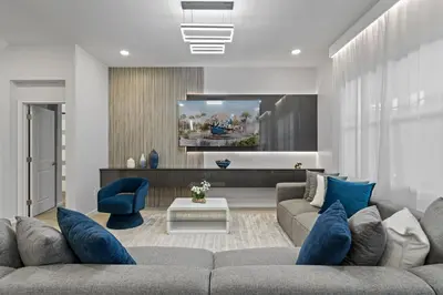 a living room with a gray couch and blue pillows at Kids Dream Vac Home Harry Potter Mickey Rooms in Orlando