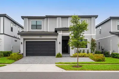 a large white house with a garage at Kids Dream Vac Home Harry Potter Mickey Rooms in Orlando