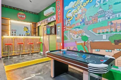a room with a ping pong table and a mural at Unforgettable Vacation: 9BR Paradiso Grand Resort in Orlando