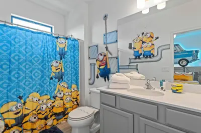 a bathroom with a shower curtain with minions at Unforgettable Vacation: 9BR Paradiso Grand Resort in Orlando