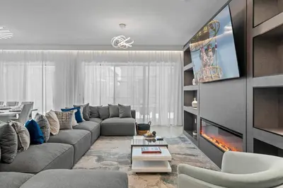 a living room with a couch and a fireplace at Unforgettable Vacation: 9BR Paradiso Grand Resort in Orlando