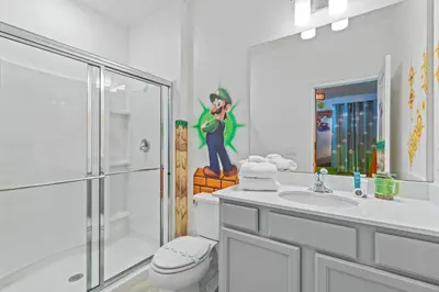 a bathroom with a shower and a toilet and a sink at Unforgettable Vacation: 9BR Paradiso Grand Resort in Orlando