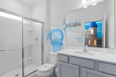 a bathroom with a shower and a toilet and a sink at Paradiso Grand Resort 6 bedroom in Orlando