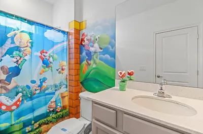 a bathroom with a toilet and a shower curtain at Paradiso Grand Resort 6 bedroom in Orlando