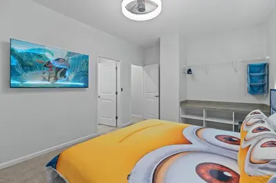 a bedroom with a bed and a painting on the wall at Luxury Living: 6BR Condo near SeaWorld ICON Park in Orlando