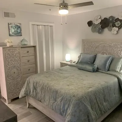 a bedroom with a large bed and a dresser at Villa del Sol in Kissimmee