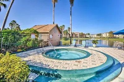a small swimming pool in a yard with a house at Villa del Sol in Kissimmee
