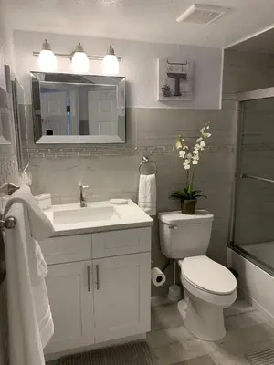 a white bathroom with a sink and a toilet at Villa del Sol in Kissimmee
