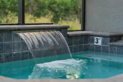 a water fountain in a swimming pool at Star Wars and Frozen, Pool, 10 min to Disney in Kissimmee