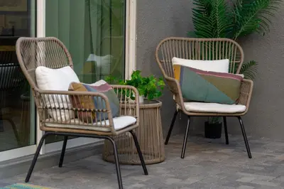 two wicker chairs with pillows sitting on a porch at Star Wars and Frozen, Pool, 10 min to Disney in Kissimmee