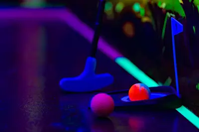 two balls in a pool table with neon lights at Amazing Game Room, Themed, Close to Disney in Kissimmee