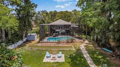 an aerial view of a house with a swimming pool at 4 Rooms, Lake, Pool, Hot Tub, Putt-Putt in Orlando