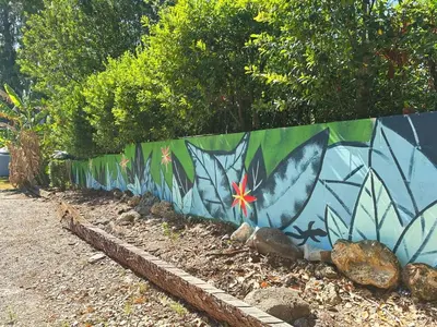 a retaining wall with a colorful mural on it at 4 Rooms, Lake, Pool, Hot Tub, Putt-Putt in Orlando