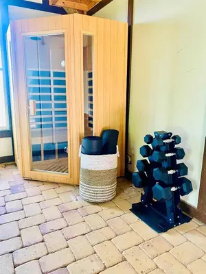 a room with a chair and a mirror at 6 Bedroom Historic Home in Orlando