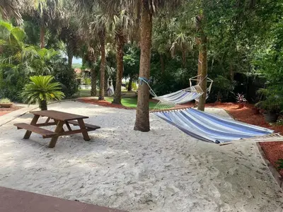 a hammock and a picnic table in a park at 6 Bedroom Historic Home in Orlando