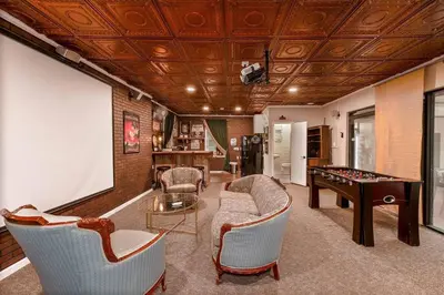 a living room with a pool table and a board at Themed Speak Easy with Pool, Hot Tub, & Lake in Orlando