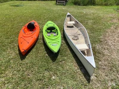 two kayaks and a boat on the grass at Themed Speak Easy with Pool, Hot Tub, & Lake in Orlando
