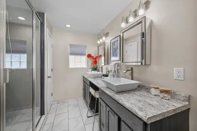 a bathroom with two sinks and a shower at New Design-Movie Night Bar-Fire Pit-Hammocks-Games in Orlando