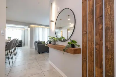 a living room with a mirror on a wall at Storey Lake Resort 1250 - Hosted by Top Villas in Kissimmee