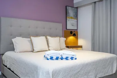 a bedroom with a white bed with two pillows on it at Storey Lake Resort 1250 - Hosted by Top Villas in Kissimmee