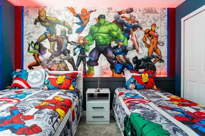 a bedroom with two beds with superheroes mural on the wall at Storey Lake Resort 363 - Hosted by Top Villas in Kissimmee