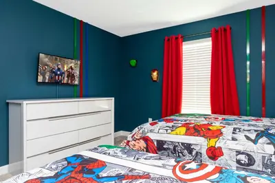 a bedroom with a bed and red curtains at Storey Lake Resort 363 - Hosted by Top Villas in Kissimmee
